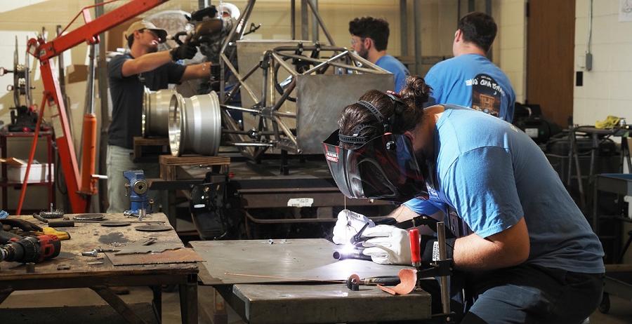 尼克长, welding in the Science Laboratory Building at the 十大彩票网投平台, is joined by other student members of South's chapter of the Society of Automotive Engineers last semester in building a hybrid vehicle to compete at the SAE Formula Hybrid Competition at the New Hampshire Motor Speedway.